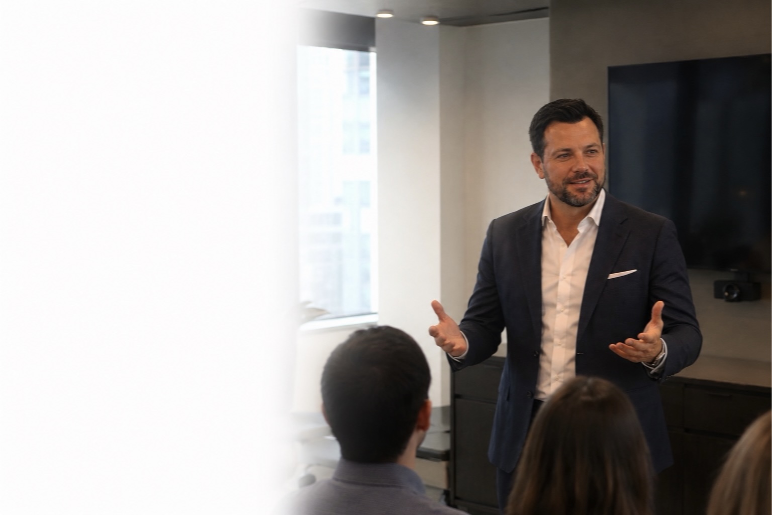 A CreditFixScore executive leading a meeting — discussing strategy with team members in a modern office